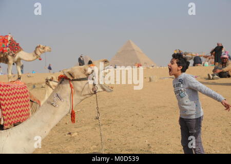 Giza, Egypt. 20th Jan, 2018. An Egyptian boy plays with a camel near the Pyramids of Giza on the outskirts of Cairo, Egypt, on Jan. 20, 2018. Credit: Ahmed Gomaa/Xinhua/Alamy Live News Stock Photo