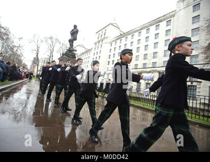 Student members of the Pipes and Drums band from Gordon's school in Surrey march past the statue of General Gordon of Khartoum in Whitehall Gardens, London, after their annual memorial service to commemorate his death. Stock Photo