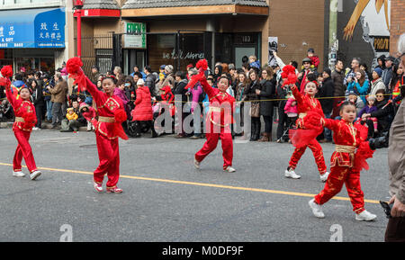 VANCOUVER, CANADA - February 2, 2014: Girls in traditional red costumes dancing at Chinese New Year parade in Vancouver Chinatown Stock Photo