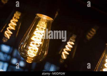 Edison lightbulb with selective focus on dark background Stock Photo