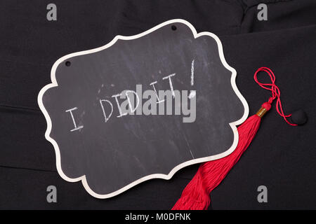 Little blank blackboard on a black graduation gown Stock Photo