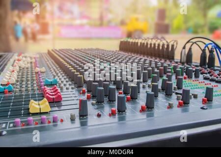 Soft blurred and soft fous the controls of sound mixing console,mixer sound with the beam light, shadow, and lens flare effect tone. Stock Photo