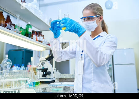Female Scientist Holding Test Tubes Stock Photo
