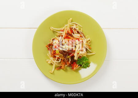 plate of assorted pickled vegetables on white wooden background Stock Photo