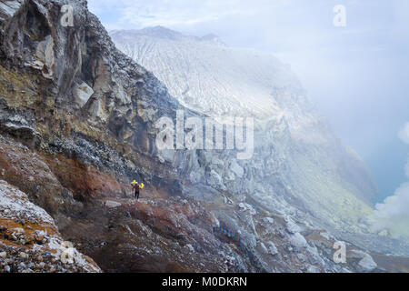 Sulfur miner in Mount Ijen (Kawah Ijen) Stock Photo