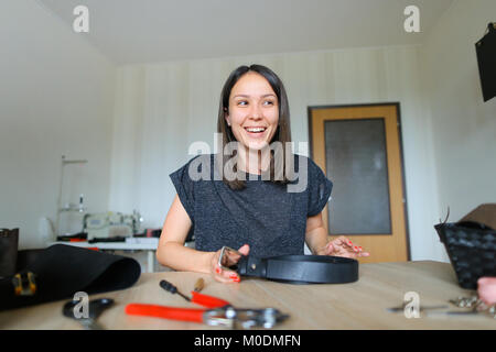 Student learning to sew zipper on purse. Stock Photo