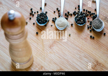 Various types of pepper on a wooden background Stock Photo