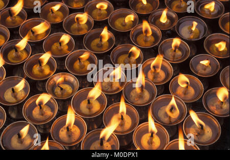 Nepal, Kathmandu. Bodnath temple, stupa (Buddhism). Night. Burning ghee butter oil lamps. Stock Photo