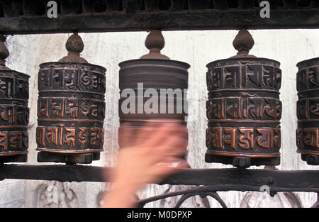 Nepal, Kathmandu. Swayambhunath temple, stupa (Buddhism). Hand spinning prayer wheel. Stock Photo