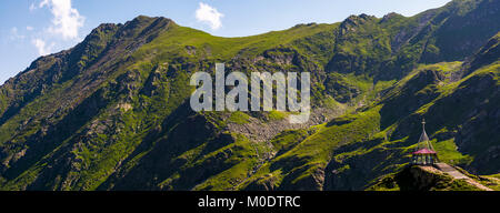 rocky mountain ridge with grassy slopes. lovely nature background Stock Photo