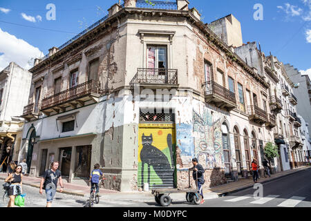 Buenos Aires Argentina,San Telmo,historic center,building,dilapidated,mural,street art,graffiti,corner,pedestrians,Black cat,Hispanic ARG171119332 Stock Photo