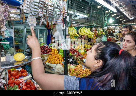 Buenos Aires Argentina,Mercado San Telmo,covered indoor inside vendor marketplace booth stall,Hispanic woman shoppers market produce fruit spices Stock Photo