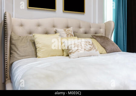 closeup of new bed comfort with decorative pillows headboard in bedroom in staging model home Stock Photo