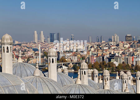 View over the Beyoglu district through the chimneys and domes of the ancient ottoman madrasa in Istanbul, Turkey. Stock Photo