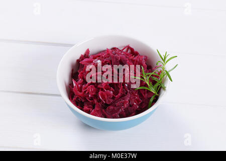 bowl of pickled red cabbage on white wooden background Stock Photo
