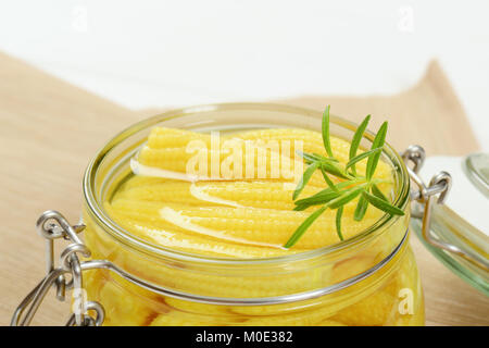 jar of sweet baby corn on beige place mat - close up Stock Photo