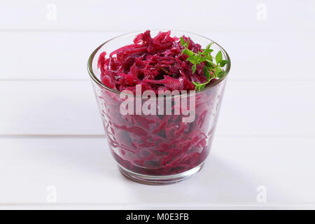 glass of pickled red cabbage on white wooden background Stock Photo