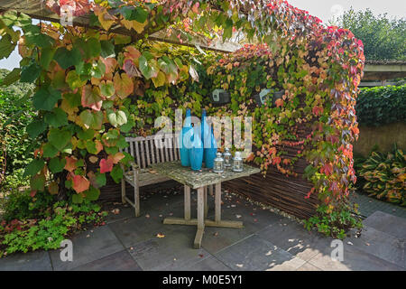 Appeltern, Netherlands, September 29, 2017: The garden set table is decorated with blue vases and lanterns Stock Photo