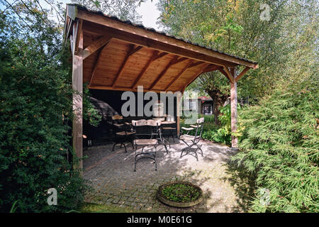 Appeltern, Netherlands, September 29, 2017:  gazebo furnished with a decorative garden set Stock Photo