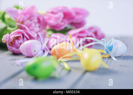 Easter composition of pink roses and colored Easter eggs Stock Photo