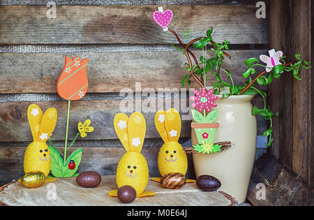 Easter composition of Easter eggs and Easter bunnies, a wriggle hazel with butterfly and heart and an artificial rabbot with carrot and flower with la Stock Photo
