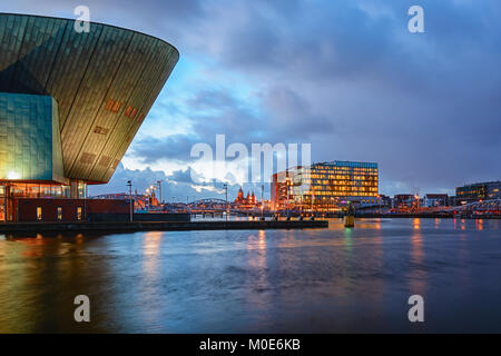 Amsterdam, Netherlands, December 16, 2017: Panorama of the Oosterdok canal in Amsterdam with the back of Nemo Science Museum on the left. Stock Photo