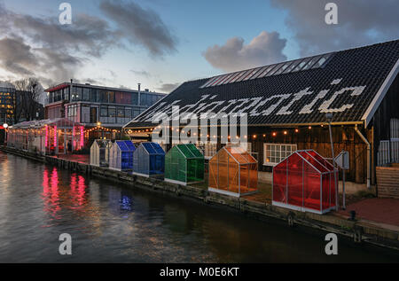 Amsterdam, Netherlands, December 16, 2017:  Colored greenhouses next to a food restaurant located at the dijksgracht in amsterdam Stock Photo