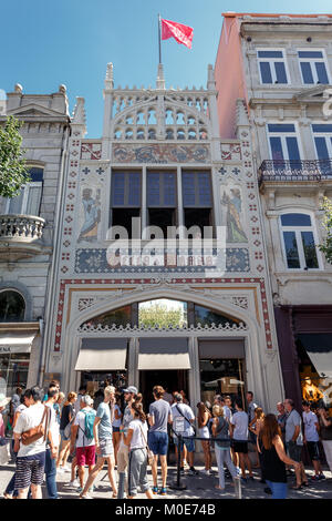 Famous Library and Book Shop Livrarira Lello in Porto, Portugal. Turist in front of Library waiting for entrance. Harry Poter Library. Stock Photo