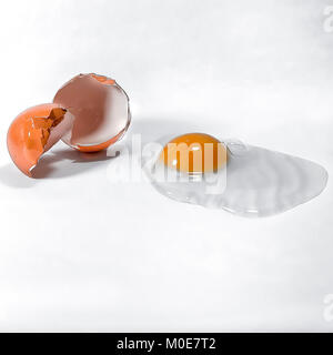 Fresh organic egg with eggshell on the side. Isolated with white background Stock Photo