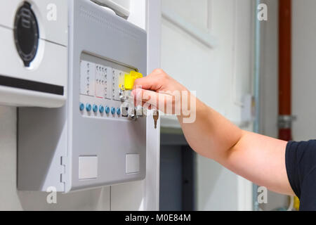 Close-up of Service Technician Opening Fire Panel In Server Room Stock Photo