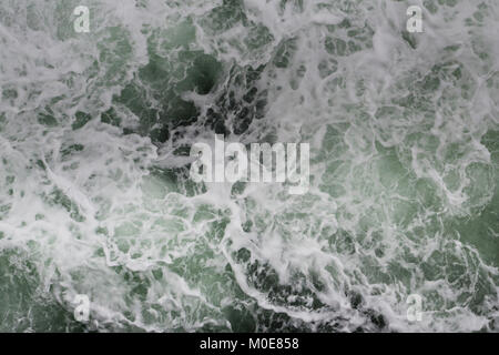 Big water splash seen from above a boat Stock Photo