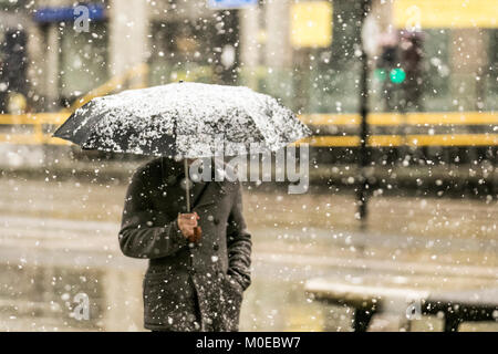 Snow showers in Manchester, UK Weather. January, 2018.  Snowing in the city centre. A wet, cloudy, cold winters day for northern England.  UK, with blustery winds forecast throughout the region. Stock Photo