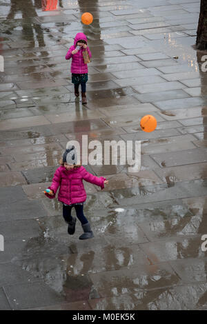 London, UK. 21st Jan, 2018. A girl enjoying splashing in puddles on a rainy day on London's South Bank Credit: On Sight Photographic/Alamy Live News Stock Photo