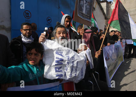 Gaza. 21st Jan, 2018. Palestinian refugees protest in front of a United Nations Relief and Works Agency for Palestine Refugees (UNRWA) distribution center in the southern Gaza Strip city of Rafah, on Jan. 21, 2018. The UNRWA will launch on Monday a funding campaign to face its budget deficit, a UNRWA official said on Sunday. Credit: Khaled Omar/Xinhua/Alamy Live News Stock Photo