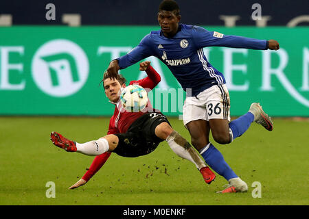 Gelsenkirchen, Germany. 21st Jan, 2018. Oliver Sorg (L) of Hannover and Breel Embolo of Schalke battle for the ball during the Bundesliga match between FC Schalke 04 and Hannover 96 at Veltins-Arena in Gelsenkirchen, Germany, Jan. 21, 2018. Credit: Joachim Bywaletz/Xinhua/Alamy Live News Stock Photo