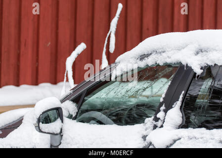 Car covered in snow an with the wipers standig out with snow on them Stock Photo