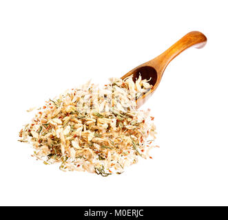 Flowers of Astragalus root on the wooden spoon. Stock Photo