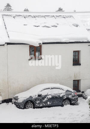 Solar panels on house covered in snow about to slide off, Llanfoist, Abergavenny, Wales, UK Stock Photo