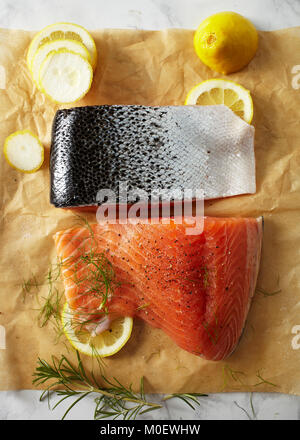 Prepared raw salmon fillets on parchment paper Stock Photo