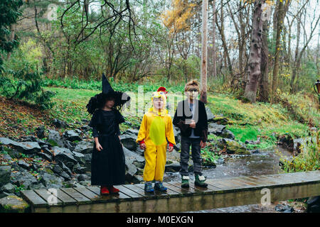 Three children dressed in fancy dress costumes for Halloween Stock Photo