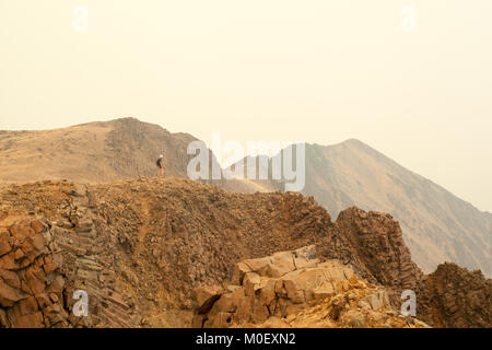 Teenage girl standing on Devil's woodpile, Cathedral Rim Trail, Cathedral Provincial Park, British Columbia, Canada Stock Photo