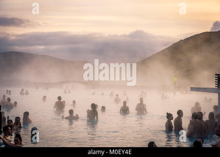 BLUE LAGOON, Reykjanes Peninsula, Iceland. Crowds of tourists and people bathing and enjoying drinks in the hot waters of geothermal bath resort Stock Photo
