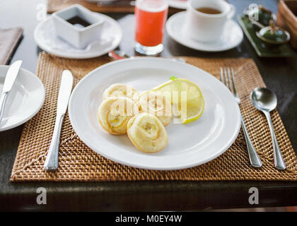 Banana pancakes, tea and grapefruit juice Stock Photo
