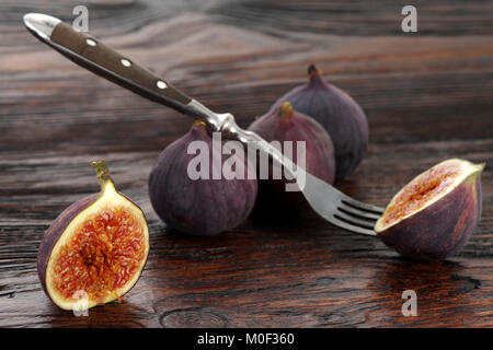 Ripe sweet figs . Healthy fig fruit on wooden table Stock Photo