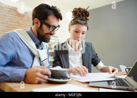 Economists discussing papers Stock Photo