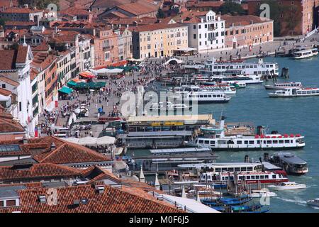 VENICE - SEPTEMBER 16: Tourists stroll along pier on September 16, 2009 in Venice. Venice Old Town is a UNESCO World Heritage Site. In summer up to 13 Stock Photo