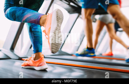 Group of friends exercising on treadmill machine Stock Photo