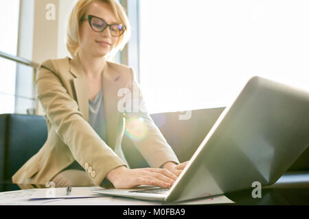 Pretty Businesswoman Wrapped up in Work Stock Photo