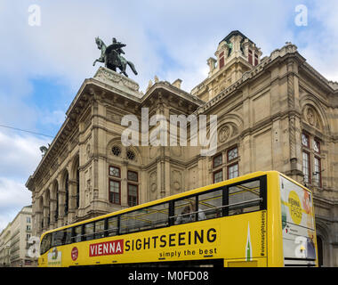 VIENNA, AUSTRIA, DECEMBER 06, 2017:  Sightseeing tour Bus passing Vienna State Opera (Wiener Staatsoper) Stock Photo