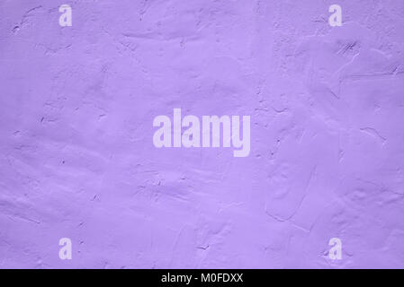 Fragment of wall covered with gypsum with traces of spatula in ultra violet tones, Ultra Violet - Pantone Color of Year 2018, style and fashion Stock Photo